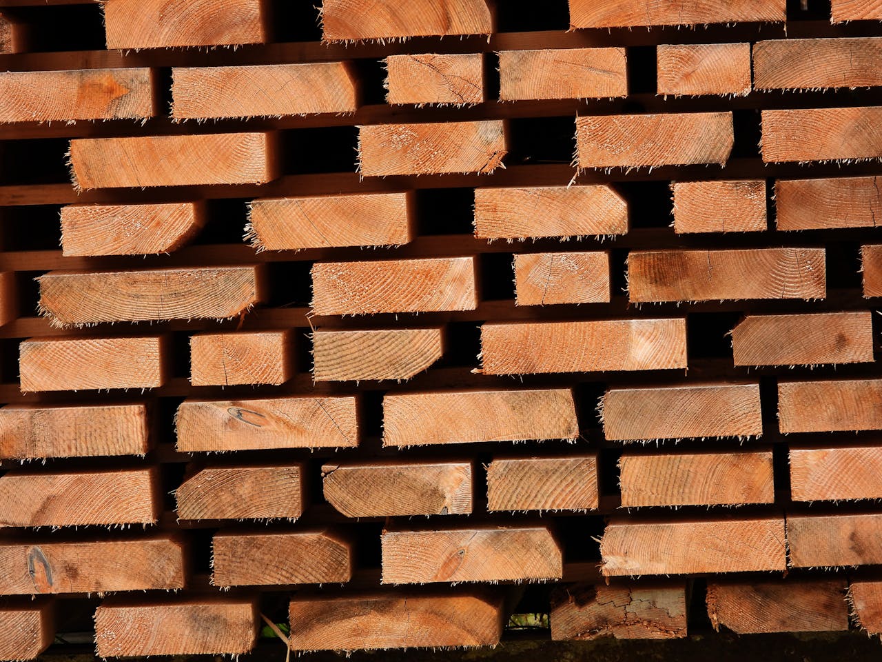 Close-up of stacked wooden planks showing texture and grain patterns.